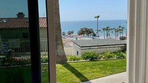 A view from a window with a clear sky and a distant ocean. - Walking distance to Beach! (San Clemente)