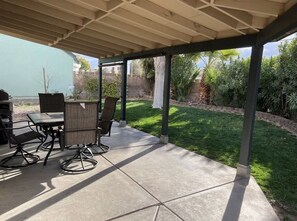 Enjoy al fresco dining and socializing in this outdoor space surrounded by lush greenery.