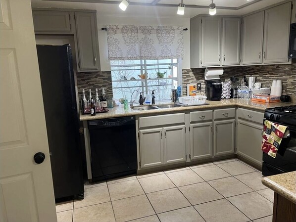 Enjoy cooking in this well-equipped kitchen with a sink, stove, and dishwasher.