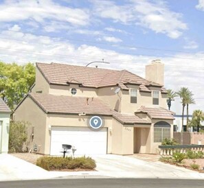 Stunning two-story home with a garage and cozy front porch.
