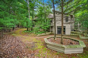 Exterior - Two-story home with a patio, sunroom, balcony, & washer/dryer access (Glen Arbor)