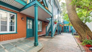 A brick building with teal trim and a covered walkway.