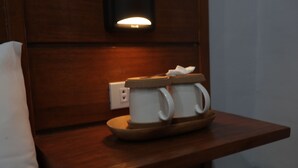 A wooden bedside table with two white mugs and a tissue box. - Cerca Hotel (Boracay Island)
