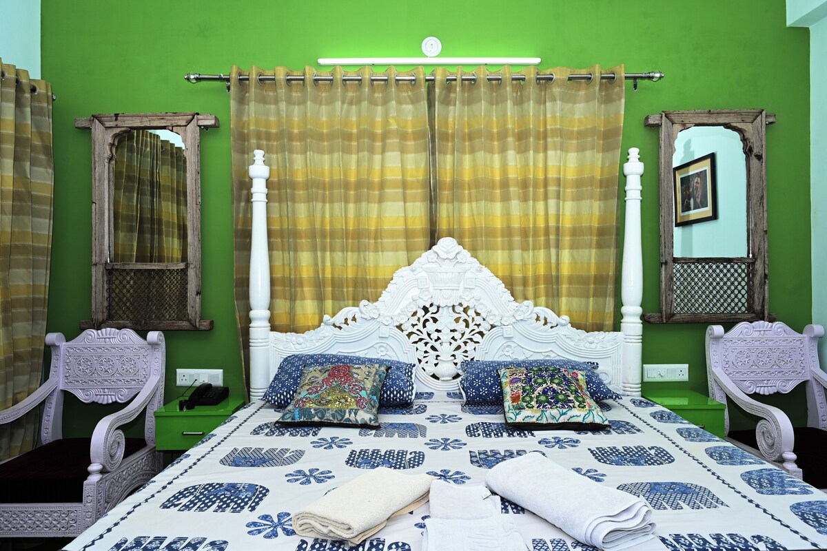 A room with a bed, curtains, and a mirror.