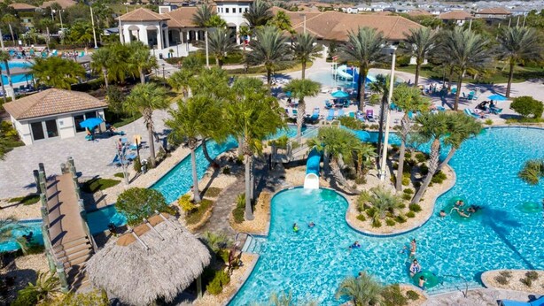 A resort with a large swimming pool, palm trees, and a thatched-roof hut. - Themed Bedrooms Private Pool Amazing Location - Super Cute Home (Davenport)