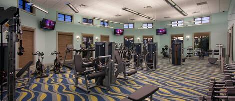 A gym with treadmills, weight machines, and exercise mats.
