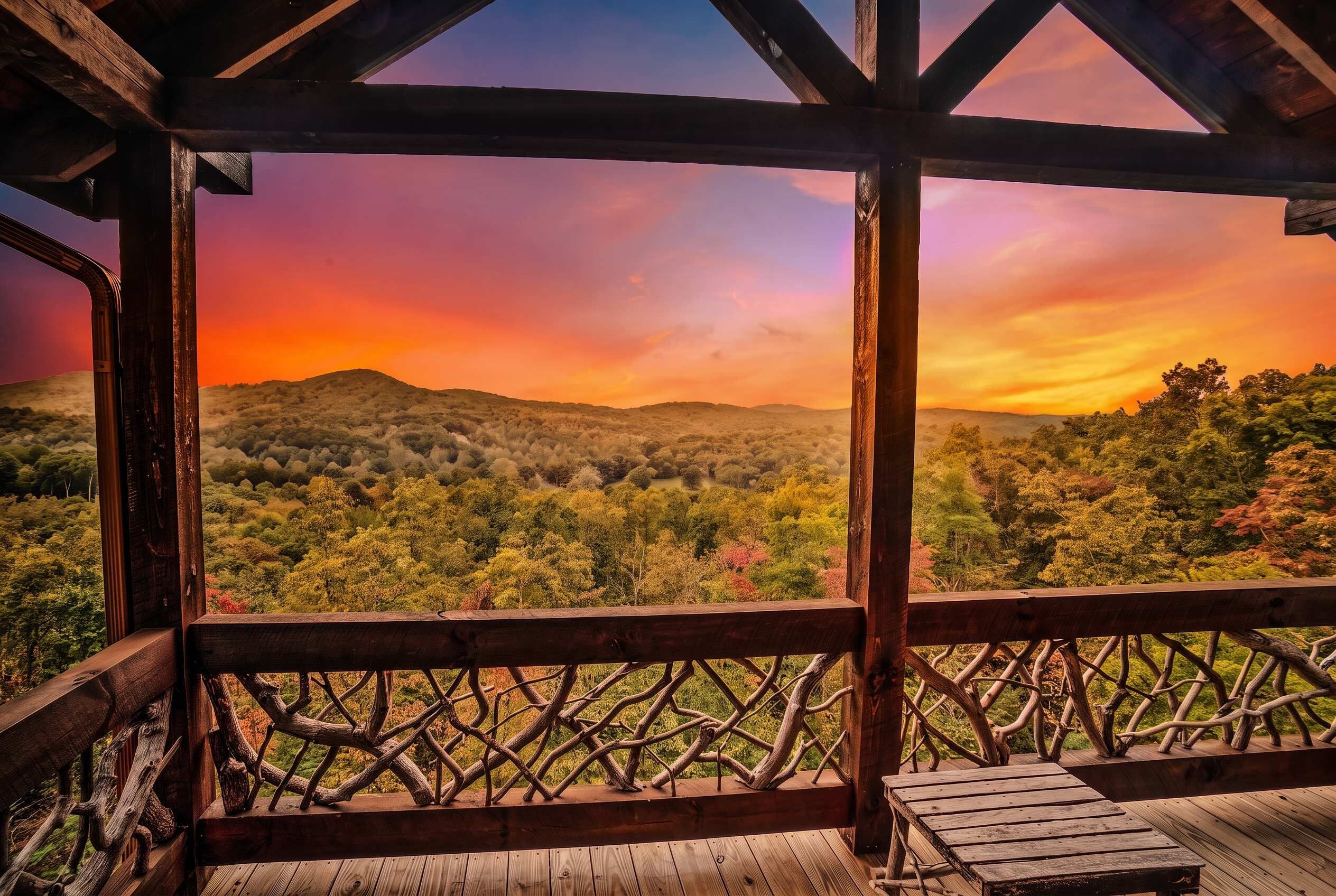 A wooden deck with a view of a forested landscape and a sunset.