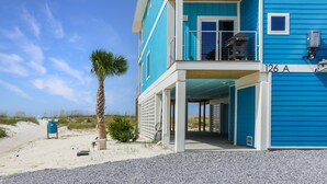 A two-story building with a blue exterior, a balcony on the upper floor, and a covered entrance. - Sea La Vie (Port St. Joe)