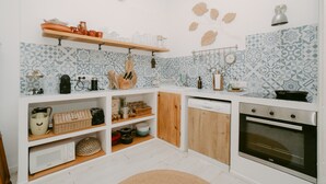 A kitchen with a microwave, oven, and various utensils on shelves. - Holiday Home 'Casa Familia' with Private Pool, Wi-Fi and Air Conditioning (Sa Pobla)