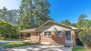 A single-story brick house with a covered porch, a front door, and a garage. - Quick Drive To Ft. Jackson, King, Full Bath, (Columbia)