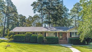 A single-story house with a brick facade, a covered porch, and a well-maintained lawn. - Quick Drive To Ft. Jackson, King, Full Bath, (Columbia)