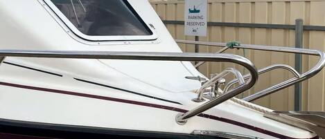 Un bote con baranda metálica y un letrero que indica 'Boat Parking Reserved'.