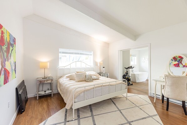 A bedroom with a bed, bedside tables, a chair, a desk, and a window. - Spacious Family Home central to Squamish (Squamish)