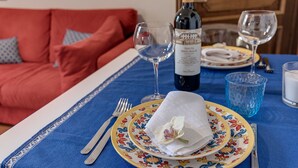 A dining table with a bottle of wine, two glasses, a folded napkin, and a plate. - Holiday Apartment "Romantic Suite Home" with Balcony & Wi-Fi (Firenze)