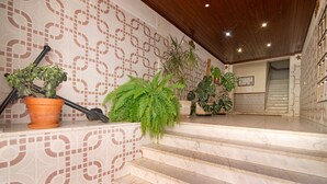A staircase with a patterned wall, potted plants, and a wooden ceiling. - Apartment 'Âncora B' with Private Terrace (Monte Gordo)