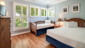 A bedroom with two beds, a ceiling fan, and large windows with shutters. - Beautiful 2BR 2BA Lakeside Villa with Lake Views (Pawleys Island)