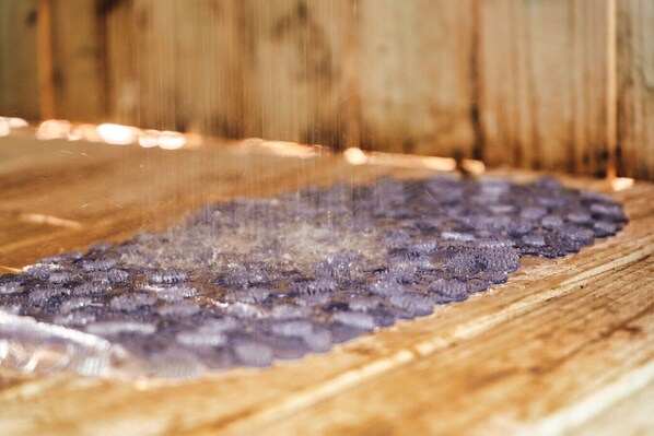 A close-up of a wooden surface with a textured, crystalline substance.