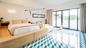 A modern hotel room with a large bed, a sofa, a desk, and a large window offering a view of the outdoors. - w* | Luxury 1BR in Santa Ana (Panamá)