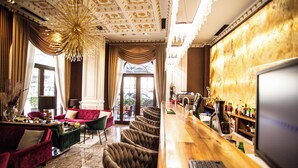 A bar area with a long counter, bar stools, and a barista station. - Envy Hotel (Durrës)