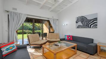 Standard Villa | Living area | 55-inch TV with cable channels