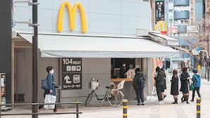 A McDonald's restaurant with a sign indicating 104 seats and a bicycle parked outside. - JR Nippori 5min | 4F New Private Room | Kitchen, Wi-Fi, Washer | Promo Rate R403 (Arakawa City)