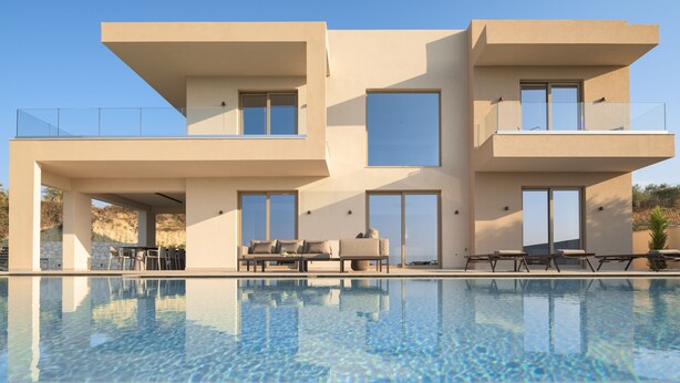 A modern two-story house with a swimming pool, outdoor seating, and large windows. - Casa Beleza Villa, a Mythical Retreat (Perama)