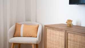A chair with a cushion, a wooden cabinet, and a television mounted on the wall. - #10 - Studio/Plateau/St-Denis/SelfCheck-In/AC/TV (Montréal)