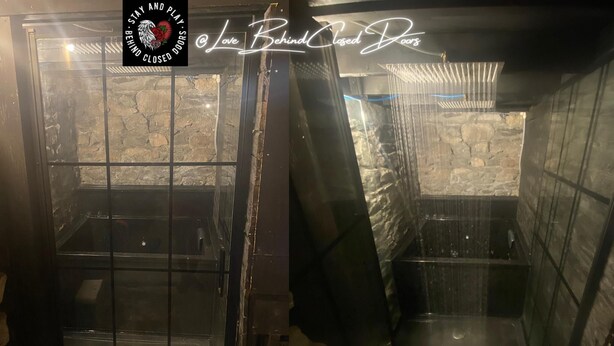 A room with a stone wall and a glass door. There is a sign that says "Love Behind Closed Doors." - Stay & Play at Lovebehindcloseddoors (Plymouth)