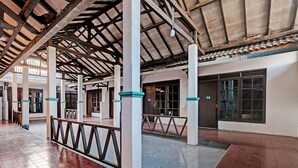 A spacious indoor area with a high ceiling and a tiled floor. - SPOT ON 92983 Hotel Ayu (Semarang)