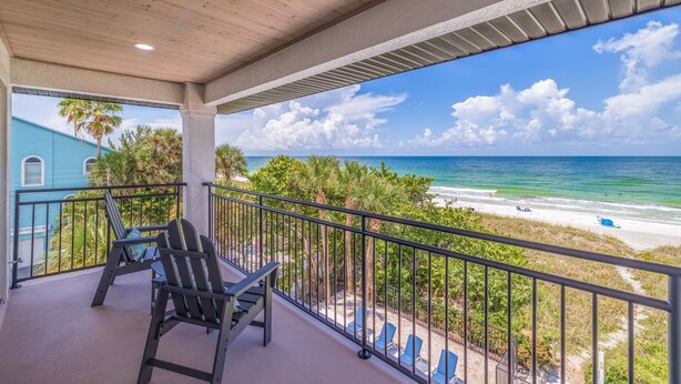 A balcony with a view of the beach and ocean. - Casa Al Mare 101 – Beachfront Luxury w/ Saltwater Pool, Private Trail, Balconies & Sunset Views (Indian Rocks Beach)