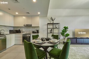 Deluxe Apartment | Living area | 32-inch LCD TV with cable channels, Netflix, streaming services - bnbme | Rahaal | 1 BDR (Dubai)