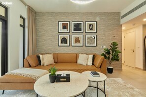 Deluxe Apartment | Living area | 32-inch LCD TV with cable channels, Netflix, streaming services - bnbme | Rahaal | 1 BDR (Dubai)