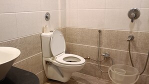 A bathroom with a toilet, bidet, and sink.
