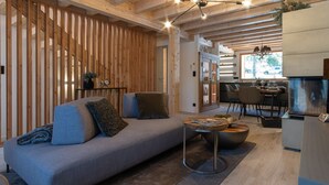 Ein gemütliches Wohnzimmer mit einer Couch, einem Couchtisch und einer Holzwand.