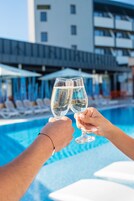 Una piscina techada, una piscina al aire libre de temporada, sombrillas