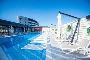 Indoor pool, seasonal outdoor pool, pool umbrellas, pool loungers