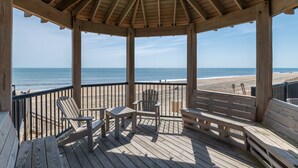 A wooden deck with a gazebo, overlooking a beach with a clear view of the ocean. - Coast Time 2 Bedroom Condo at Croatan Surf Club (Kill Devil Hills)