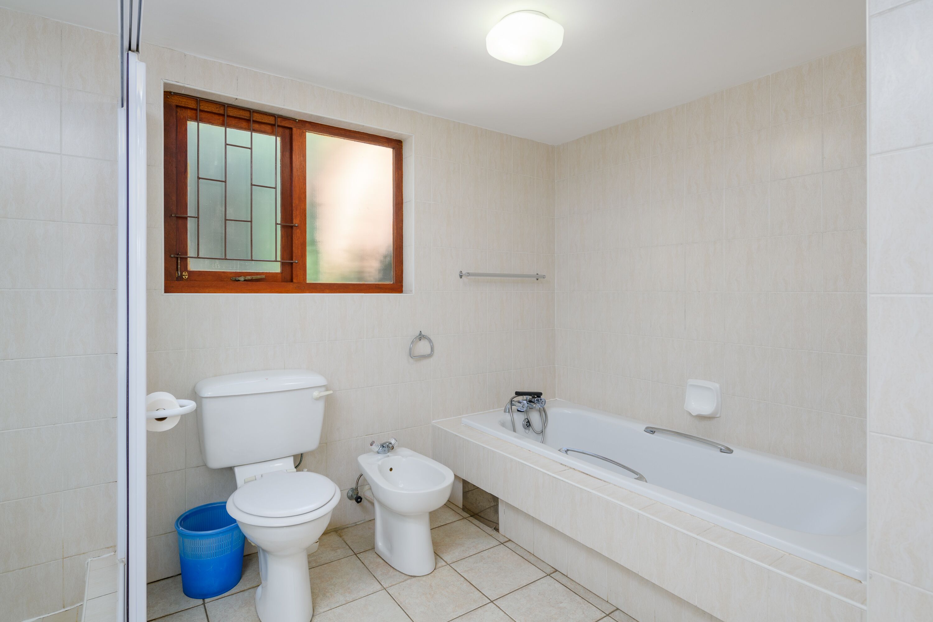 A bathroom with a toilet, bidet, and bathtub.