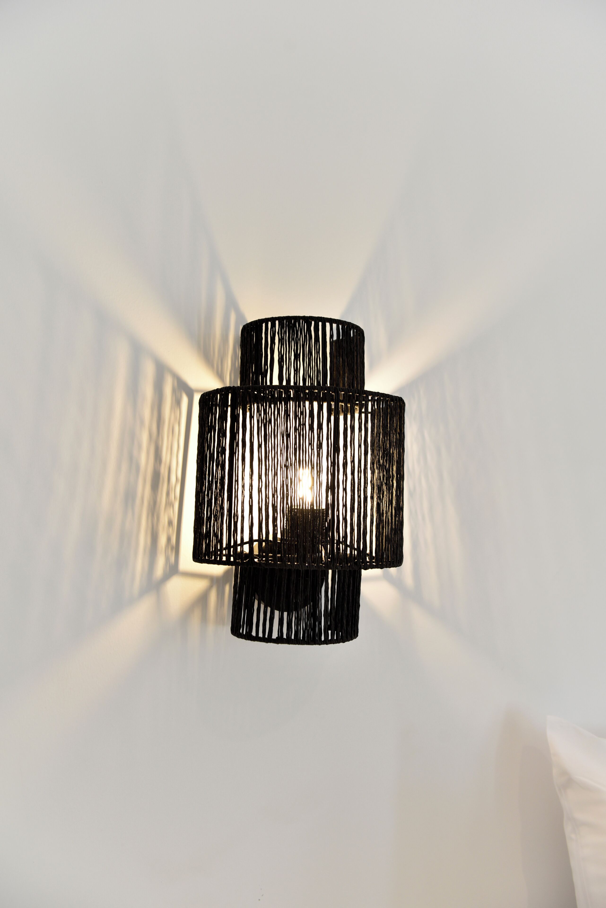 A modern, cylindrical pendant light fixture with a ribbed texture, hanging from a ceiling.