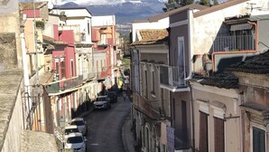 A narrow street lined with buildings, some with balconies and others with ground-level windows. - Motta Palace Apartments and Rooms (Motta Sant'Anastasia)