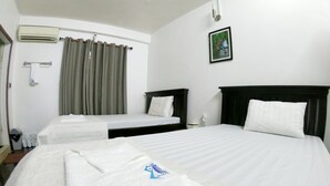 A hotel room with two beds, a bathroom, and a window with curtains. - Sarah Guest House (Siem Reap)