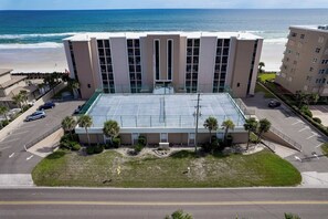 A multi-story hotel with a flat roof, a parking lot, and a view of the beach. - Oceanfront Condo on traffic free beach - Great views from 403 Lighthouse Shores (Ponce Inlet)