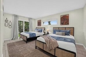 A hotel room with two beds, a large window, and a view of greenery. - Indigo Oasis, Pool, Sleeps 18 (Phoenix)