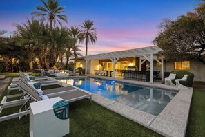 A pool area with lounge chairs, a bar, and a covered seating area. - Indigo Oasis, Pool,  Sleeps 18 (Phoenix)