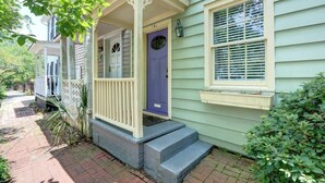 A house with a porch, a blue door, and a window with shutters. - The Tea Olive - A, Fresh | Updated | Dog-Friendly (Savannah)
