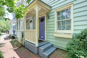 A house with a porch, a blue door, and a window with shutters. - The Tea Olive - A, Fresh | Updated | Dog-Friendly (Savannah)