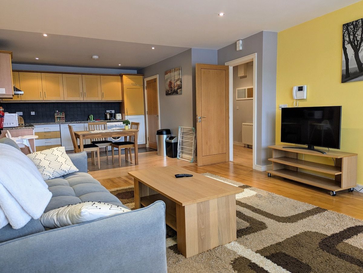 Ein modernes Wohnzimmer mit Sofa, Couchtisch und TV-Möbel.