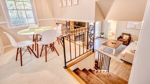 A modern interior with a dining area, staircase, and living space. - Spacious Retreat Near Lake Hartwell, Clemson & Greenville! (Anderson)