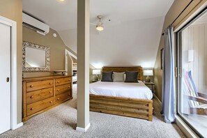 A bedroom with a wooden bed, a dresser, a mirror, and a window with curtains. - Village Loft 31 At Park City Mountain 2 Bedroom Condo by RedAwning (Park City)