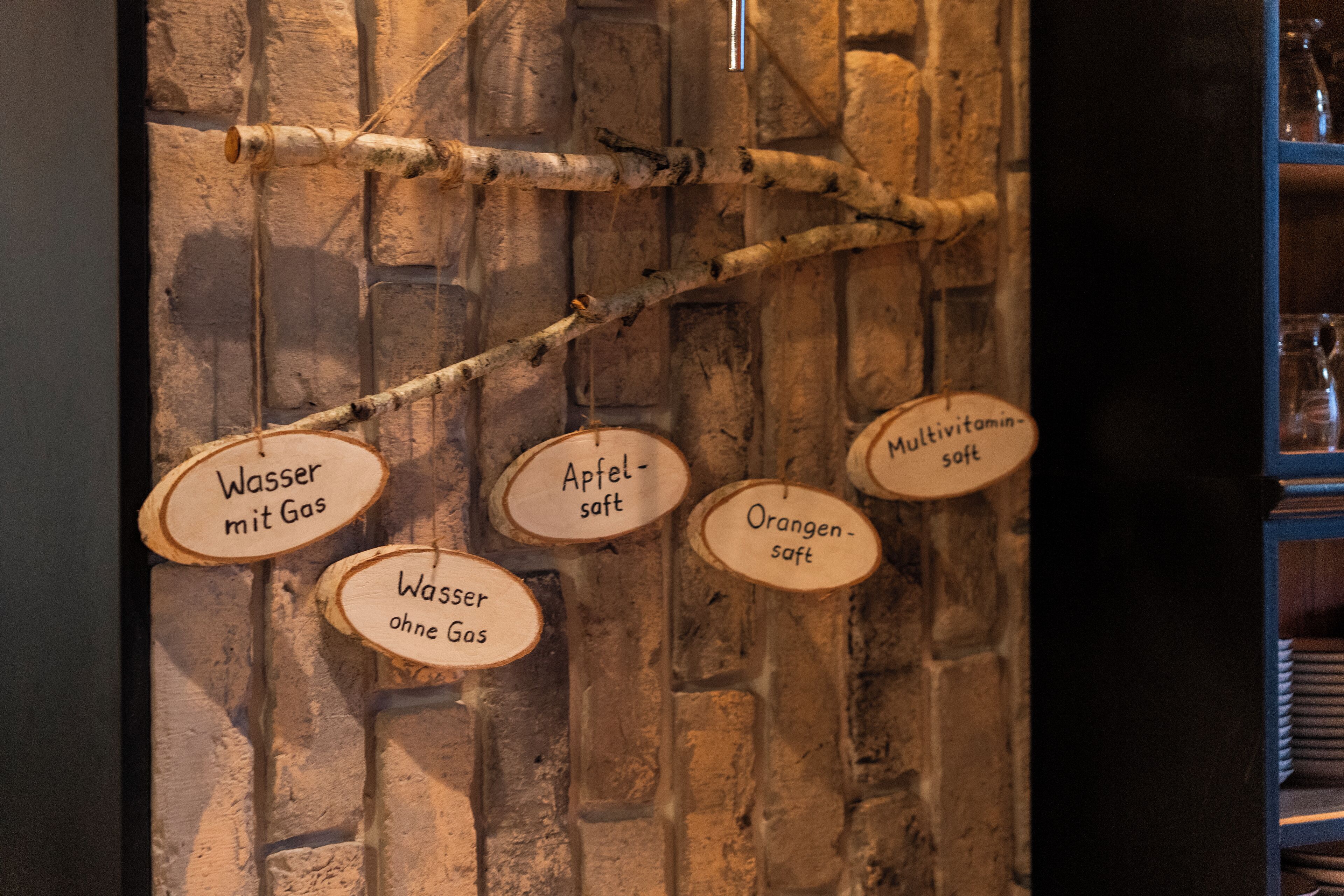 A wall with wooden branches and signs indicating different types of water and salt.